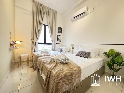 two beds in a white room with a window at Ipoh Horizon Skypool Town Suites 4-11pax by IWH Suites in Ipoh