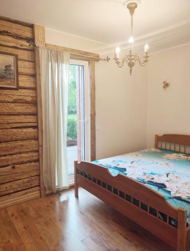 a bedroom with a bed and a large window at Muraka Apartement in Pärnu