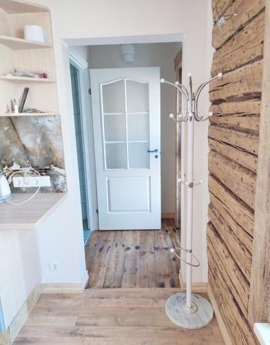 a room with a white door and a wooden floor at Muraka Apartement in Pärnu