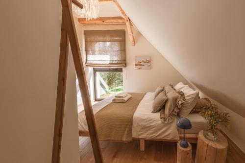 a small bedroom with a bed in a attic at Rycerki Dom na Szlaku in Rajcza