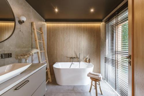 a bathroom with a white tub and a sink at Rycerki Dom na Szlaku in Rajcza