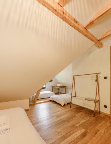 a attic bedroom with two beds and wooden floors at Rycerki Dom na Szlaku in Rajcza