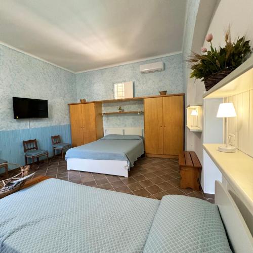 a bedroom with two beds and a tv in it at Il Sentiero in Bari
