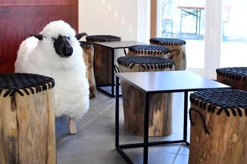 a sheep standing in a room with tables and chairs at krenzers rhön in Melperts