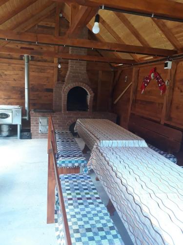 a bedroom with two beds in a room with a fireplace at Cabana Claudia Briciu in Arieşeni
