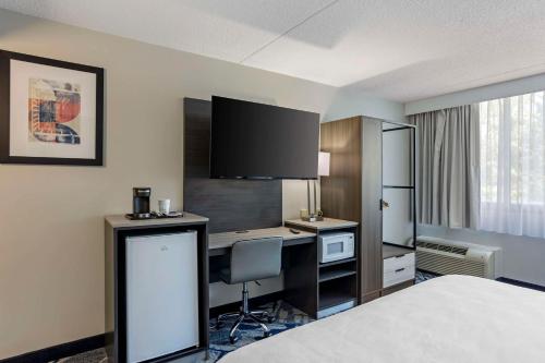 a hotel room with a bed and a desk at Best Western Rutgers University Hotel in East Brunswick