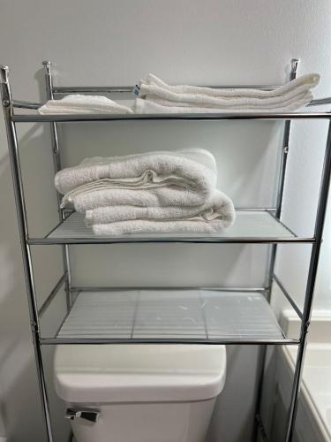 a towel is sitting on a shelf above a toilet at Travelodge by Wyndham Gallipolis in Gallipolis