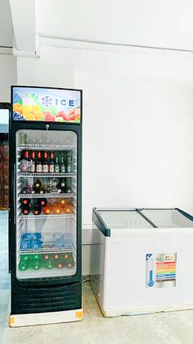 a refrigerator filled with lots of drinks next to a counter at Tranquil residence Hotel in Abidjan