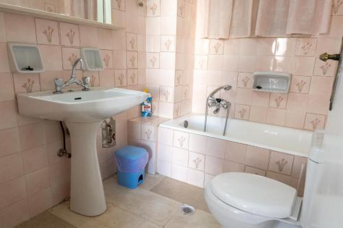a bathroom with a sink and a toilet at Unbeatable View, Family apartment in Rafina