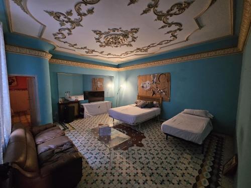 a living room with two beds and a coffered ceiling at Fabrica de Sueños in Gandía