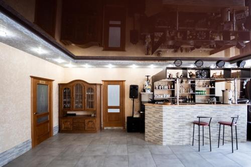 a bar in a room with two stools at Hotel Duet in Maydan