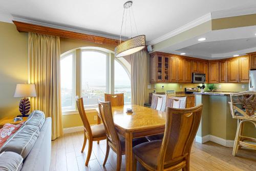 a kitchen and dining room with a table and a couch at Belmont Towers 801 in Ocean City