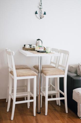 a white table with two chairs and a table at Premium apartments in Ulcinj