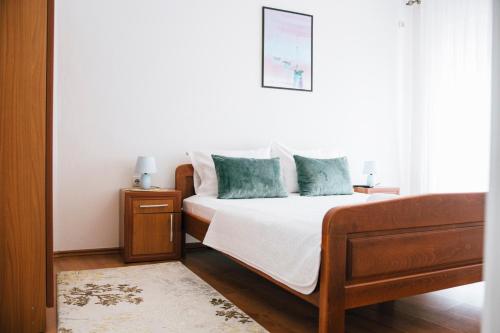 a bedroom with a bed with blue pillows at Premium apartments in Ulcinj