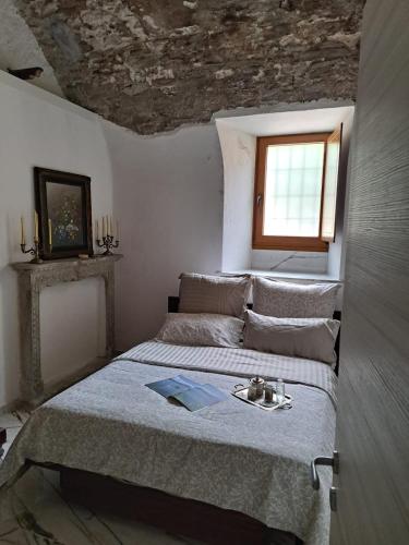 a bedroom with a bed with a stone ceiling at Casa alla Cascata in Cunardo