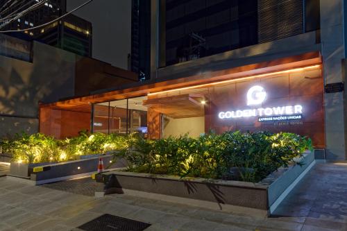 a building with a sign on the side of it at Golden Tower Express Nações Unidas by Fênix Hotéis in Sao Paulo