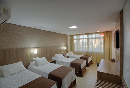 Postel nebo postele na pokoji v ubytování Foz Presidente Comfort Hotel