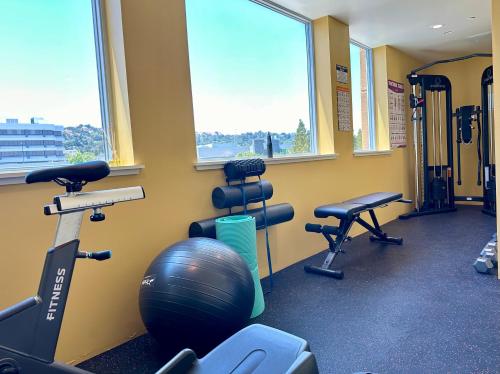 a gym with exercise equipment and a large window at Elevator-Downtown View-Garage-King Bed-Laundry in Walnut Creek