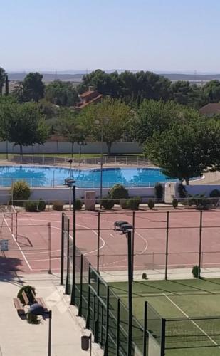 a tennis court with a tennis court at Las casitas del Gallego in Villanueva de Gállego