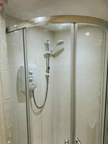 a shower in a bathroom with a glass door at Stylish Modern 1-Bed Apartment in Prime Solihull Town Centre in Solihull