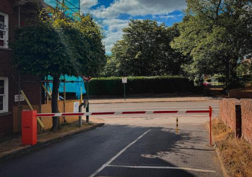 a street with a red and white barrier on the road at Stylish Modern 1-Bed Apartment in Prime Solihull Town Centre in Solihull