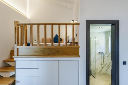 a bathroom with a walk in shower and a crib at Ioanna House in Skopelos Town