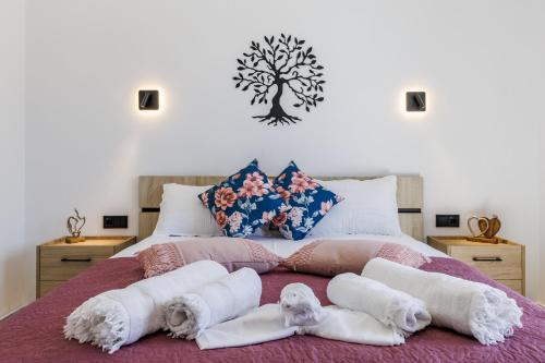 a bedroom with a bed with towels on it at Ioanna House in Skopelos Town