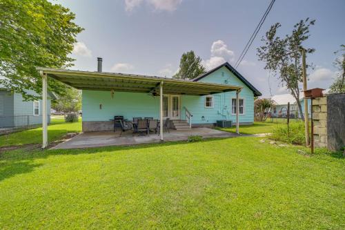 a small blue house with a covered patio at Eufaula Home - Walk to Lake Beach! in Eufaula