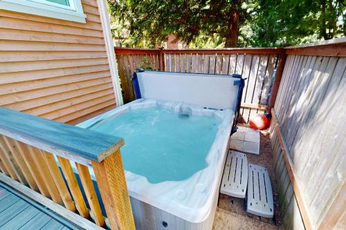 a hot tub on the back of a house at Bella Beach Home in Depoe Bay