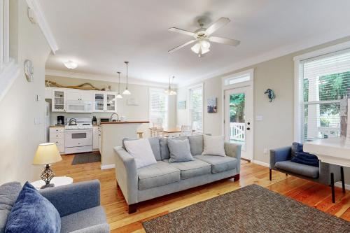 a living room with a couch and a kitchen at Bella Beach Home in Depoe Bay