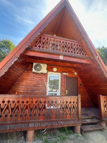 a log cabin with a camera on the front of it at Domek w Górach Opawskich nad Złotym Potokiem nr 2A in Pokrzywna