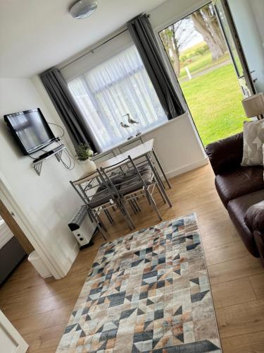 a living room with a table and chairs and a couch at Tranquility at Sandown Bay in Sandown