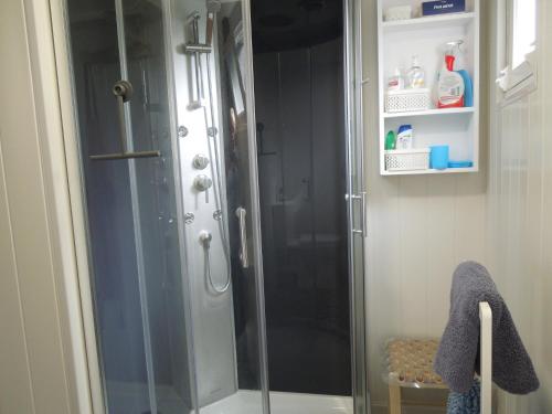 a shower with a glass door in a bathroom at Chez Pauline, Gavray. House with secure parking, Wi-Fi & garage. in Gavray