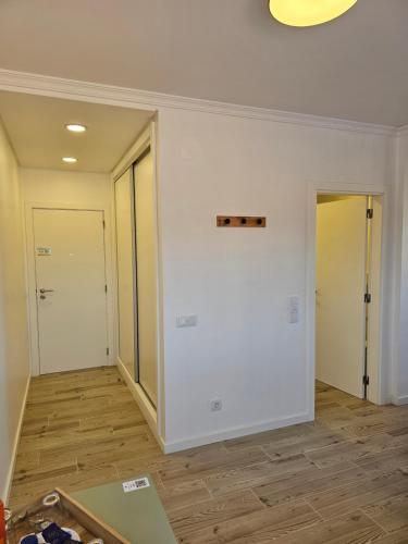 an empty room with white walls and wooden floors at Ideal Bubble House in Faro