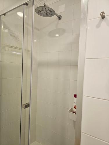 a shower with a glass door in a bathroom at Ideal Bubble House in Faro