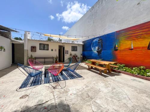 a group of chairs and a table in front of a wall at The Boat House Cancun in Cancún