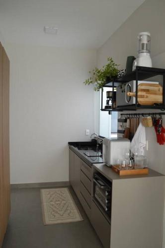 a kitchen with a stove and a counter top at Kitnet equipada e aconchegante in Passos