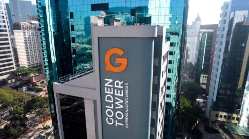 a sign on top of a building in a city at Golden Tower Express Nações Unidas by Fênix Hotéis in Sao Paulo