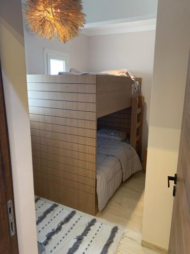 a bedroom with a bunk bed in a room at Luxury Twin Villa in Mountain View Ras Elhikma in Ras Elhekma
