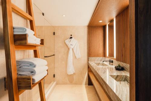 a bathroom with a sink and a towel rack at Nobu Hotel Miami Beach in Miami Beach