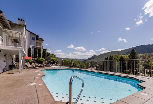 a swimming pool with mountains in the background at Park Pointe: Splendor on the Sun Deck (C202) in Chelan