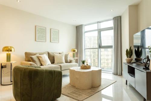a living room with a couch and a table at Elegant City Centre Apartment 2 Bedroom With Free Parking in Cardiff