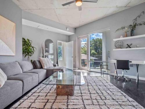 a living room with a couch and a glass table at Lovely 2Bdrm 2Bath Thorton Park Condo with secure parking in Orlando