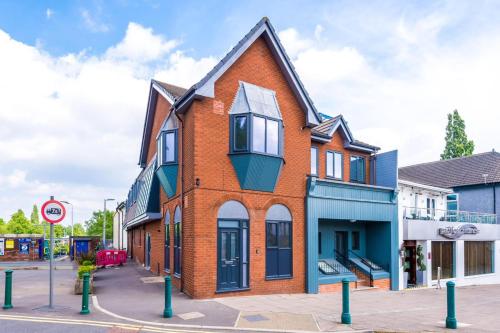 a red brick building on a street at Apartment 1 in Manchester