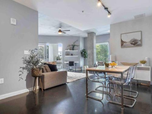 a living room with a table and a couch at Lovely 2Bdrm 2Bath Thorton Park Condo with secure parking in Orlando