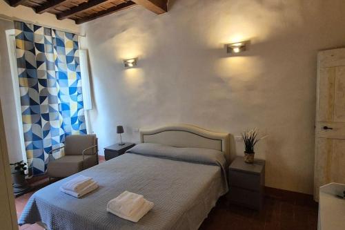 a bedroom with a bed with two towels on it at Borgo San Frediano Hideaway in Florence