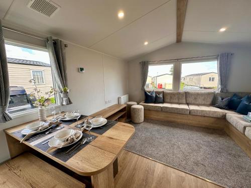 a living room with a table and a couch at Eden Holiday Home in Whitley Bay
