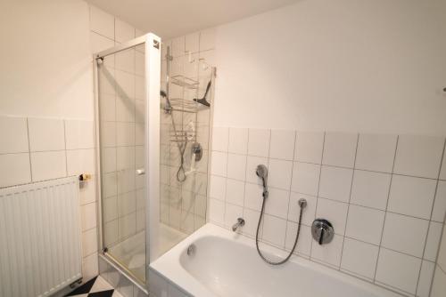 a bathroom with a shower and a bath tub at Wohnen auf privater Reitanlage in Münsingen