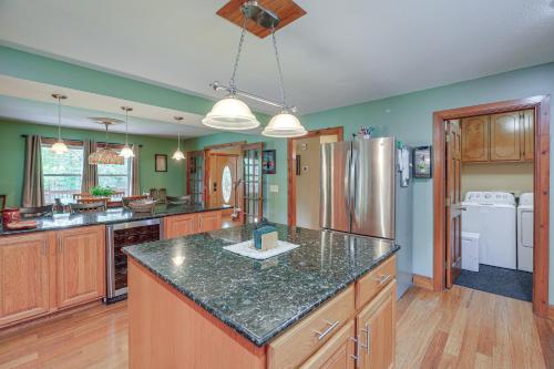 a kitchen with wooden cabinets and a counter top at Peaceful Bluff City Retreat with Fire Pit and Grill in Bluff City