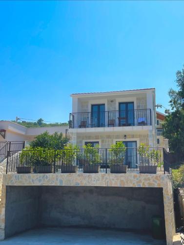 a building with a balcony with plants on it at Villa Regulus in Tivat